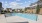 swimming pool with lounge chairs around it