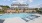 swimming pool with lounge chairs in the background