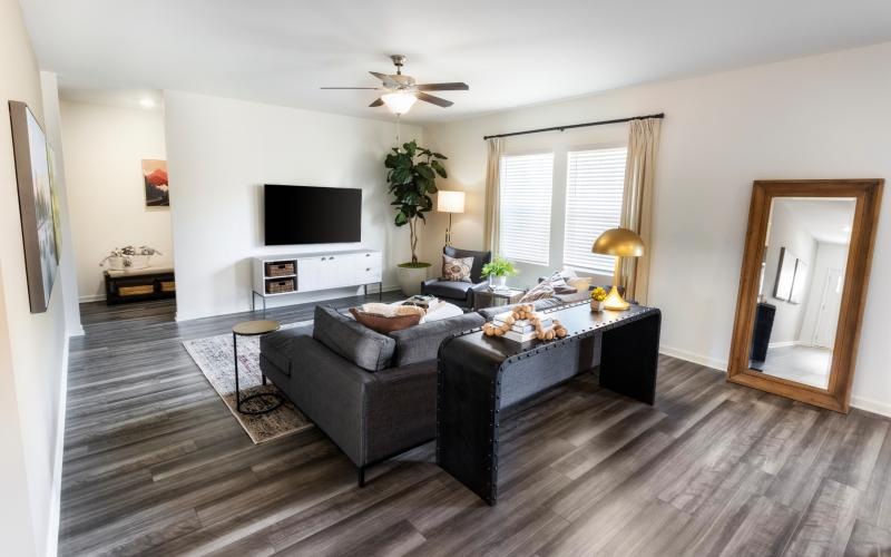 a living room with a large television and a couch